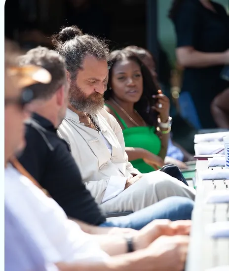 Community members gathered together outdoors in the sun