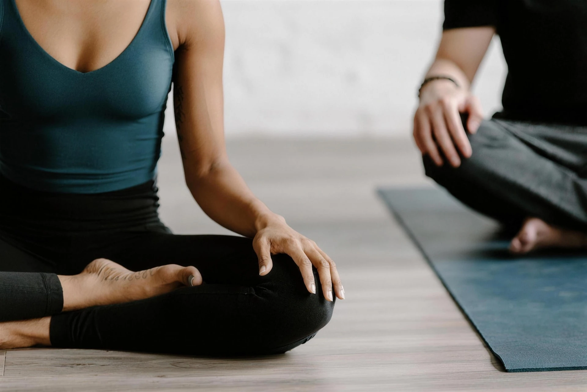 Two people resting in seated meditation during practice