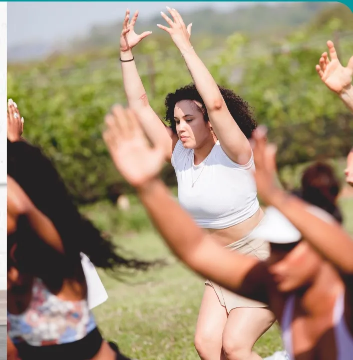 A group practising yoga together outdoors